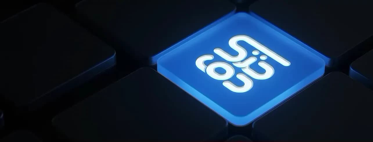 A backlit keyboard key carrying the Al Doha Tech mark